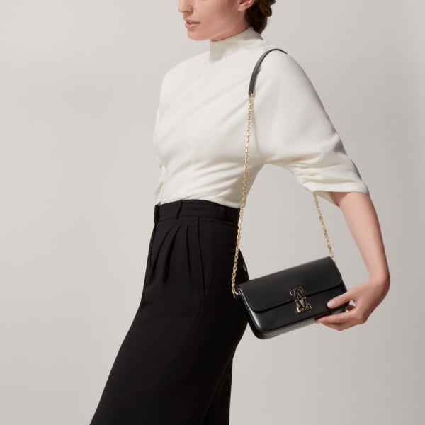 Mini chain bag, C de Cartier Black calfskin, gold and black enamel finish