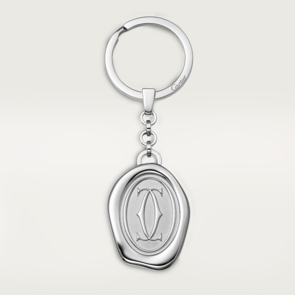 Key ring with wax seal décor: Stainless steel key ring with wax seal décor. Dimensions: 34.4mm high x 26 mm wide